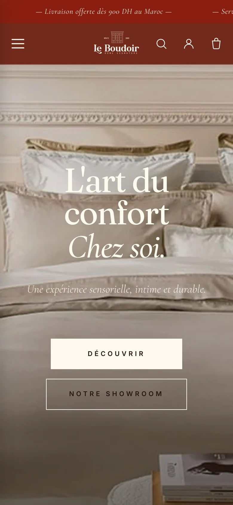 The same Le Boudoir store on a phone: the terracotta bar, a condensed header, and the bedroom photograph with the headline stacked above full-width buttons.